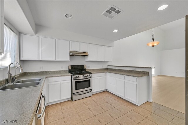 4708 Cohiba Way N, Las Vegas, NV 89031 - kitchen with stainless steel range with gas stovetop, under cabinet range hood, white cabinetry, a peninsula, and recessed lighting