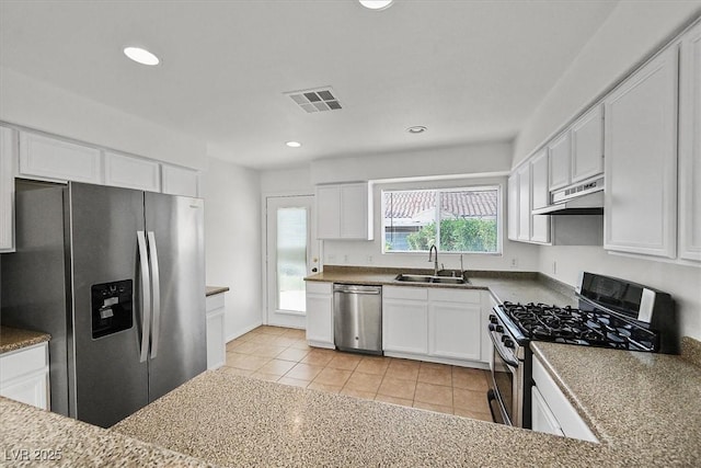 4708 Cohiba Way N, Las Vegas, NV 89031 - kitchen featuring appliances with stainless steel finishes, under cabinet range hood, white cabinets, recessed lighting, and light tile patterned floors
