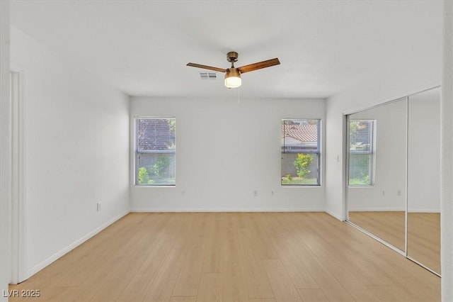 4708 Cohiba Way N, Las Vegas, NV 89031 - unfurnished bedroom with light wood-type flooring and ceiling fan