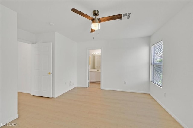 4708 Cohiba Way N, Las Vegas, NV 89031 - unfurnished bedroom featuring light wood-style floors, ensuite bath, and ceiling fan