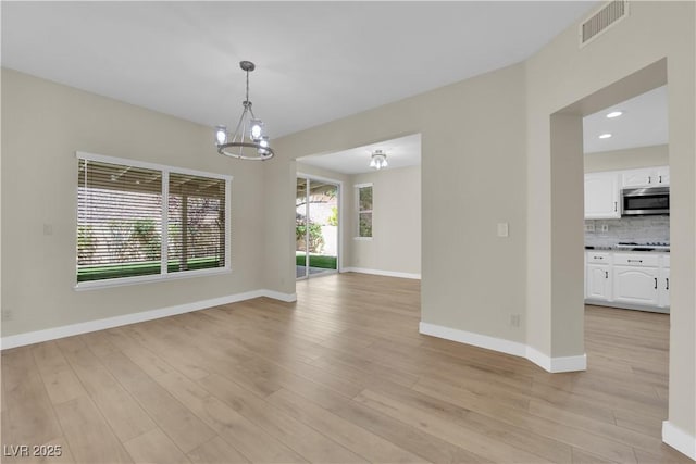 7837 Sea Rock Rd, Las Vegas, NV 89128 - empty room featuring light wood-style floors, a chandelier, and recessed lighting