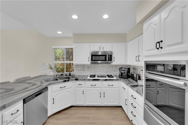 7837 Sea Rock Rd, Las Vegas, NV 89128 - kitchen featuring appliances with stainless steel finishes, light stone counters, decorative backsplash, and recessed lighting