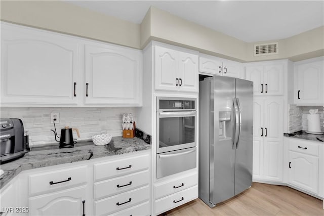 7837 Sea Rock Rd, Las Vegas, NV 89128 - kitchen with stainless steel appliances, a warming drawer, light stone countertops, and decorative backsplash