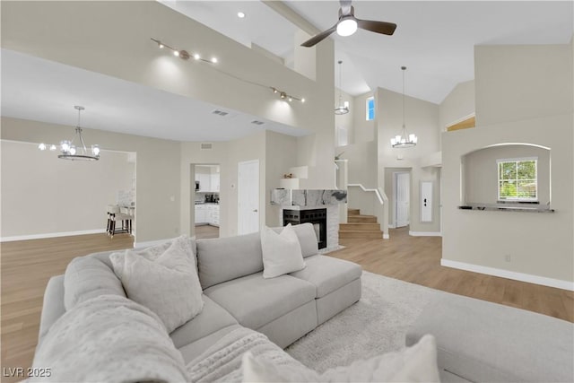 7837 Sea Rock Rd, Las Vegas, NV 89128 - living room with a chandelier, wood finished floors, a ceiling fan, and high vaulted ceiling