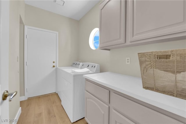 7837 Sea Rock Rd, Las Vegas, NV 89128 - laundry area with washing machine and clothes dryer, light wood-style floors, and cabinet space