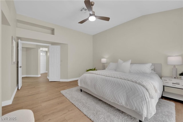 7837 Sea Rock Rd, Las Vegas, NV 89128 - bedroom featuring light wood-style flooring, vaulted ceiling, and a ceiling fan