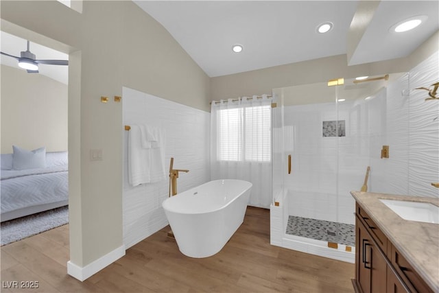 7837 Sea Rock Rd, Las Vegas, NV 89128 - bathroom with a stall shower, lofted ceiling, vanity, a freestanding bath, and wood finished floors