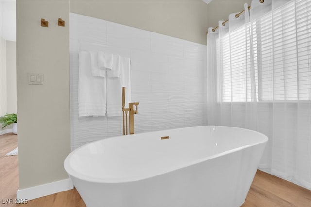 7837 Sea Rock Rd, Las Vegas, NV 89128 - full bath featuring wood finished floors and a freestanding tub