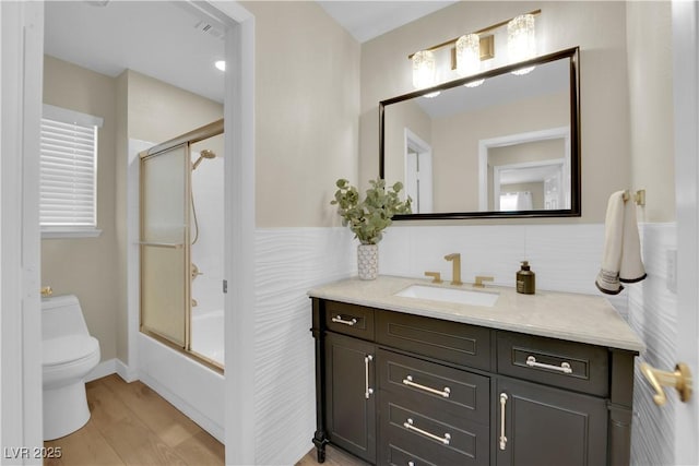7837 Sea Rock Rd, Las Vegas, NV 89128 - full bathroom featuring vanity, shower / bath combination with glass door, and wood finished floors