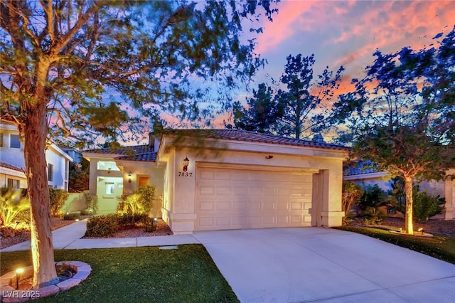 7837 Sea Rock Rd, Las Vegas, NV 89128 - view of front of property with a tiled roof, driveway, a garage, and stucco siding
