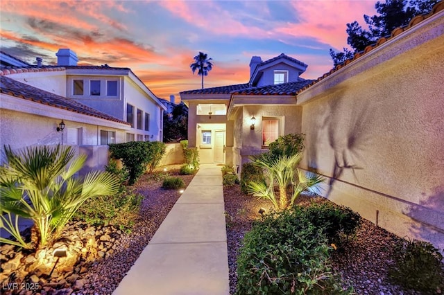 7837 Sea Rock Rd, Las Vegas, NV 89128 - view of exterior entry featuring stucco siding and a tile roof