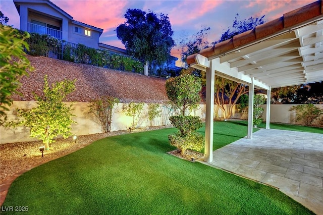 7837 Sea Rock Rd, Las Vegas, NV 89128 - yard at dusk featuring a fenced backyard, a patio area, and a pergola