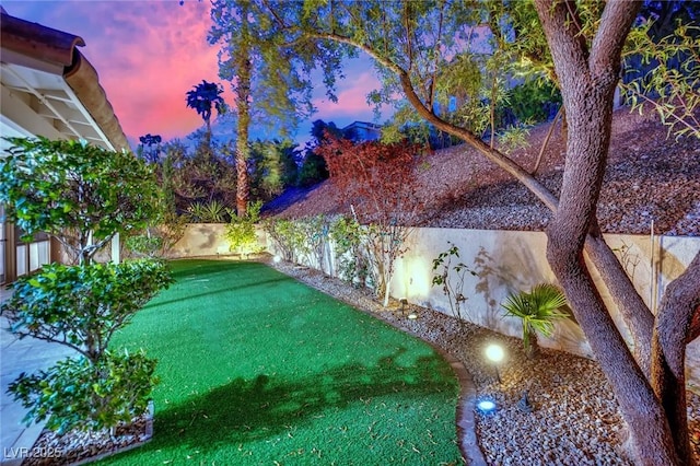7837 Sea Rock Rd, Las Vegas, NV 89128 - yard at dusk with a fenced backyard