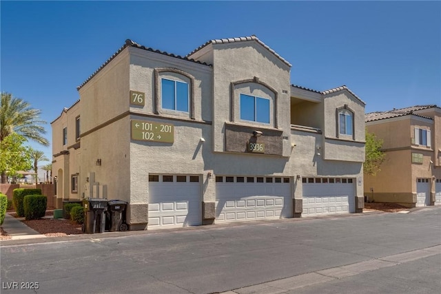 3936 Pepper Thorn Ave Unit 3, North Las Vegas, NV 89081 - view of front of house featuring stucco siding, a garage, and a tile roof