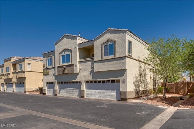 3936 Pepper Thorn Ave Unit 3, North Las Vegas, NV 89081 - view of front of home with stucco siding, driveway, a garage, and a tiled roof