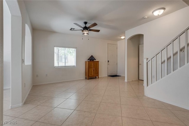 3936 Pepper Thorn Ave Unit 3, North Las Vegas, NV 89081 - unfurnished room with arched walkways, a ceiling fan, light tile patterned floors, a smoke detector, and stairs
