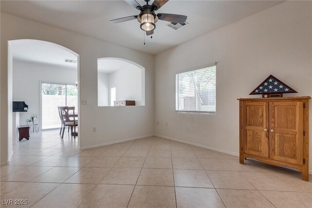 3936 Pepper Thorn Ave Unit 3, North Las Vegas, NV 89081 - spare room with light tile patterned floors, arched walkways, and ceiling fan