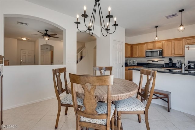 3936 Pepper Thorn Ave Unit 3, North Las Vegas, NV 89081 - dining area with a ceiling fan, stairway, light tile patterned floors, and arched walkways