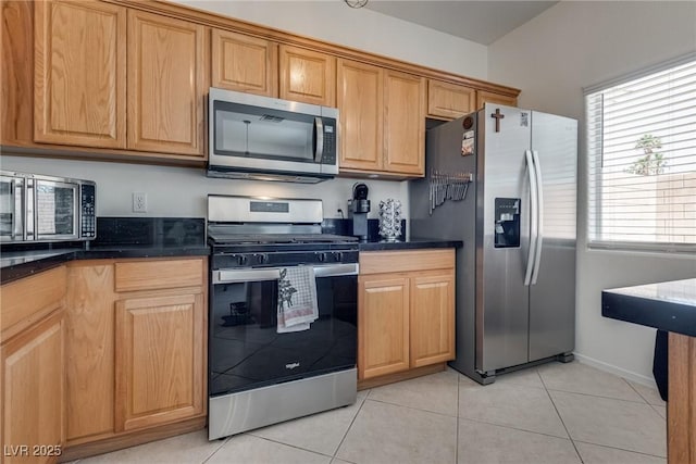 3936 Pepper Thorn Ave Unit 3, North Las Vegas, NV 89081 - kitchen with appliances with stainless steel finishes, dark countertops, and light tile patterned flooring