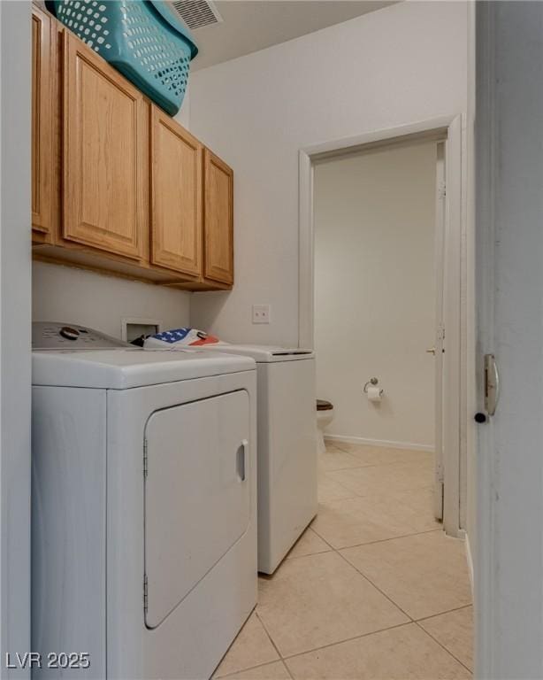 3936 Pepper Thorn Ave Unit 3, North Las Vegas, NV 89081 - laundry room with washer and clothes dryer, cabinet space, and light tile patterned floors