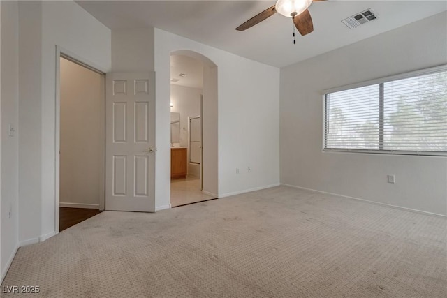 3936 Pepper Thorn Ave Unit 3, North Las Vegas, NV 89081 - unfurnished bedroom with arched walkways, carpet, connected bathroom, and a ceiling fan