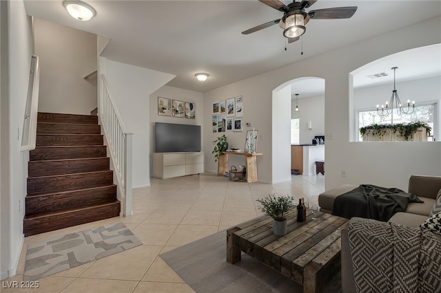 3936 Pepper Thorn Ave Unit 3, North Las Vegas, NV 89081 - living room with ceiling fan, light tile patterned flooring, arched walkways, stairs, and a chandelier