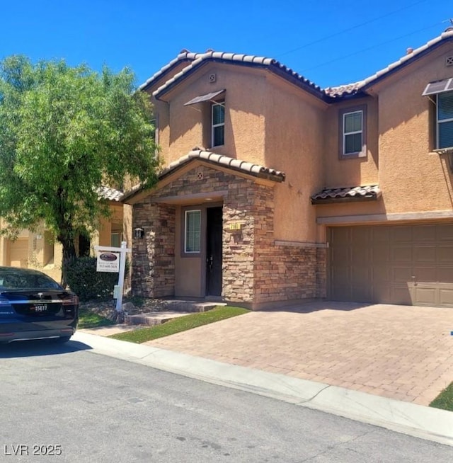 7160 Mineral Park Ave, Las Vegas, NV 89179 - mediterranean / spanish-style house with a tiled roof, a garage, stone siding, stucco siding, and decorative driveway