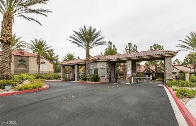 2200 S Fort Apache Rd Unit 2217, Las Vegas, NV 89117 - view of asphalt road featuring a gate, curbs, and a gated entry