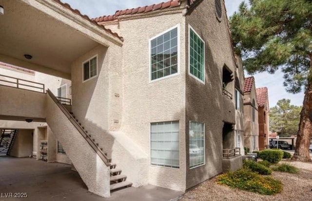 2200 S Fort Apache Rd Unit 2217, Las Vegas, NV 89117 - view of home's exterior featuring stairs, stucco siding, and a tile roof