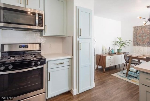 2200 S Fort Apache Rd Unit 2217, Las Vegas, NV 89117 - kitchen featuring stainless steel appliances, light countertops, dark wood-style floors, and decorative backsplash