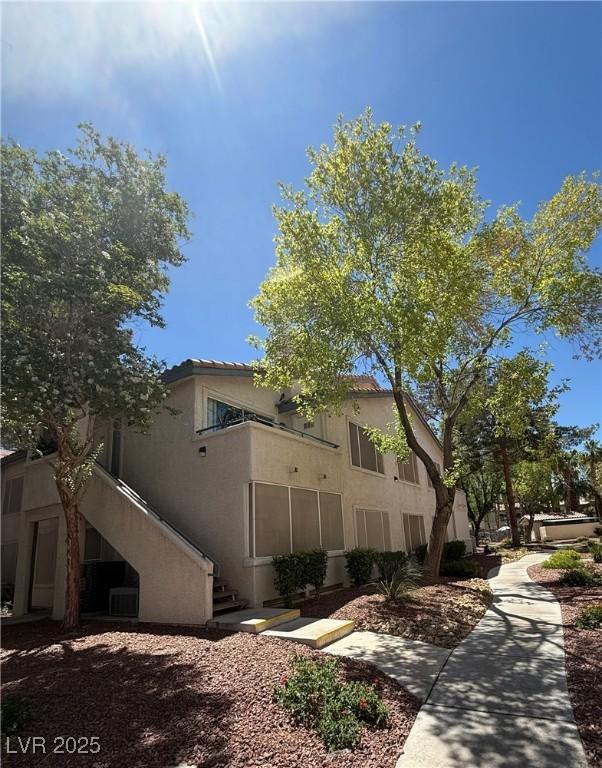 3055 Key Largo Dr Unit 204, Las Vegas, NV 89120 - view of front facade featuring stairway and stucco siding