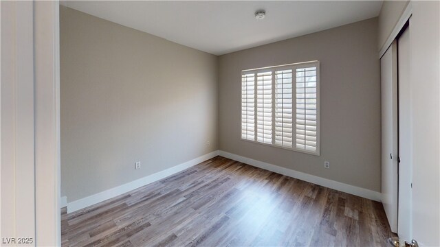 8070 W Russell Rd Unit 1046, Las Vegas, NV 89113 - empty room featuring a smoke detector and wood finished floors