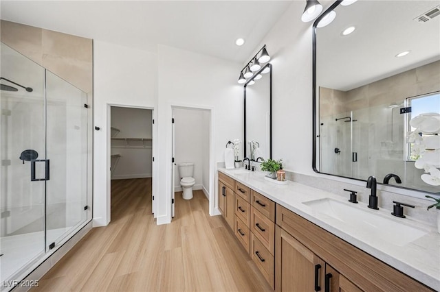 2297 Aria Dr, Henderson, NV 89052 - full bath featuring double vanity, a stall shower, wood finished floors, recessed lighting, and a spacious closet