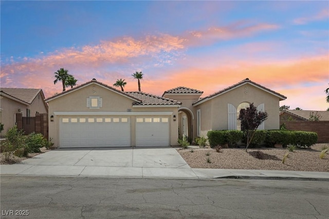 2297 Aria Dr, Henderson, NV 89052 - mediterranean / spanish house with a garage, stucco siding, concrete driveway, and a tiled roof
