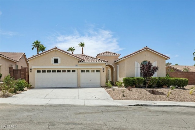 2297 Aria Dr, Henderson, NV 89052 - mediterranean / spanish-style home featuring a garage, stucco siding, concrete driveway, and a tiled roof