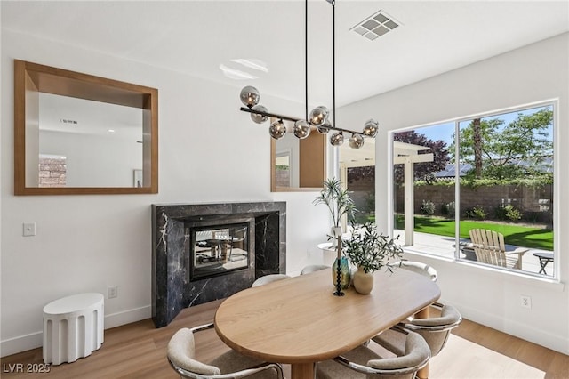 2297 Aria Dr, Henderson, NV 89052 - dining area featuring a high end fireplace and wood finished floors