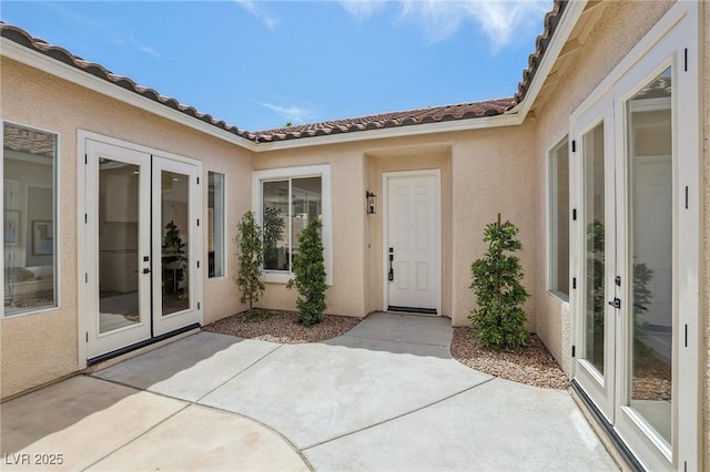 2297 Aria Dr, Henderson, NV 89052 - entrance to property featuring french doors, a patio area, stucco siding, and a tile roof