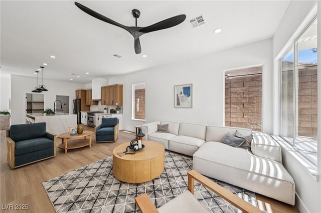 2297 Aria Dr, Henderson, NV 89052 - living room featuring a ceiling fan, light wood-style floors, and recessed lighting