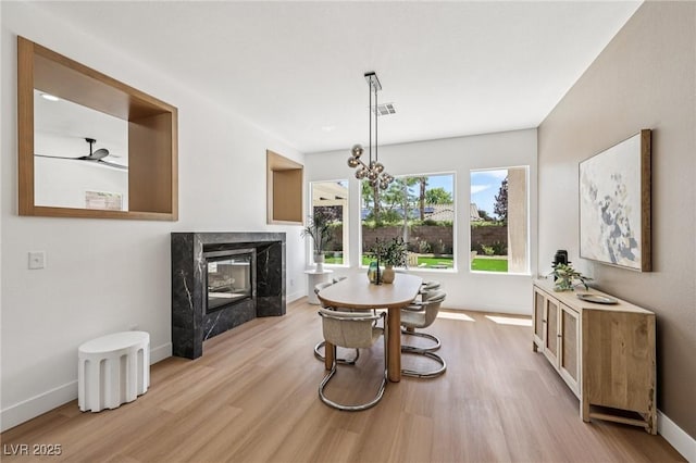 2297 Aria Dr, Henderson, NV 89052 - dining area featuring a high end fireplace and wood finished floors