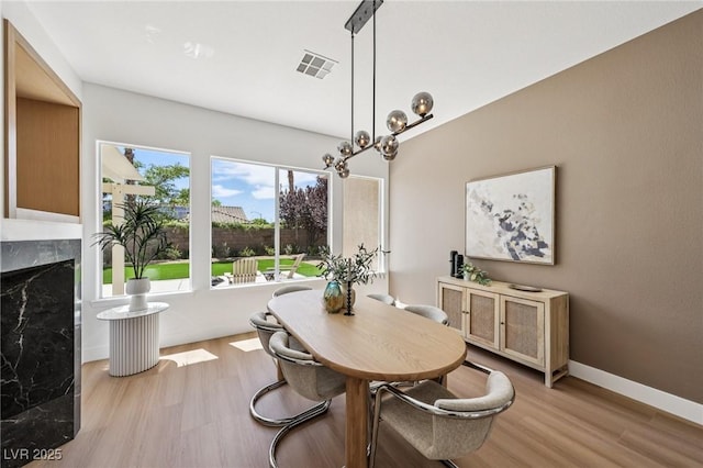 2297 Aria Dr, Henderson, NV 89052 - dining area featuring wood finished floors and a high end fireplace