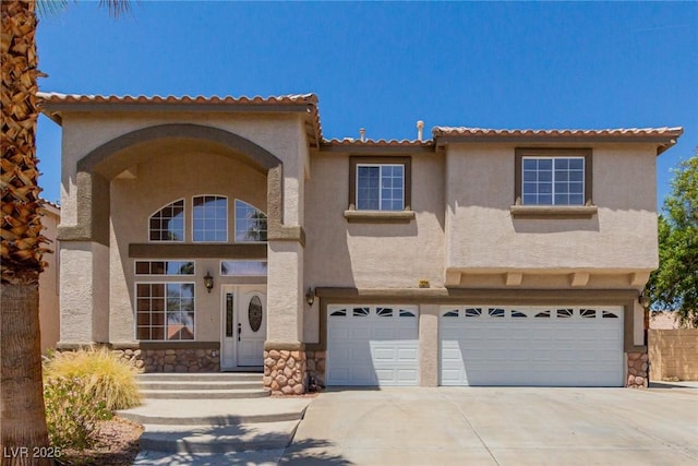 1054 Broomfield Dr, Henderson, NV 89074 - mediterranean / spanish-style home with an attached garage, stone siding, concrete driveway, and stucco siding