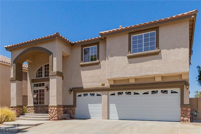 1054 Broomfield Dr, Henderson, NV 89074 - mediterranean / spanish-style house featuring stone siding, an attached garage, stucco siding, and driveway