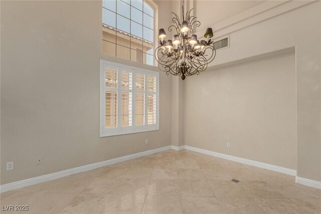 1054 Broomfield Dr, Henderson, NV 89074 - spare room with a chandelier, light tile patterned flooring, and a high ceiling