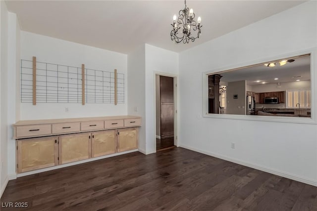 1054 Broomfield Dr, Henderson, NV 89074 - unfurnished dining area with dark wood-type flooring and a chandelier