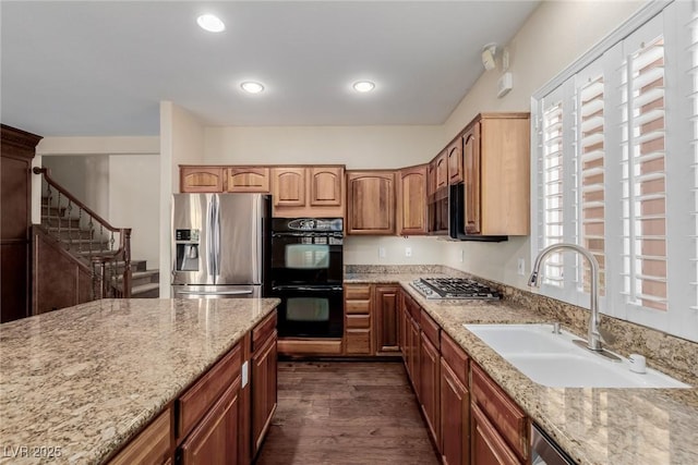 1054 Broomfield Dr, Henderson, NV 89074 - kitchen with appliances with stainless steel finishes, light stone countertops, dark wood-style flooring, and recessed lighting