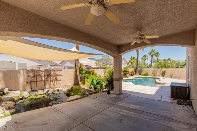 1054 Broomfield Dr, Henderson, NV 89074 - fenced backyard with a ceiling fan and a patio