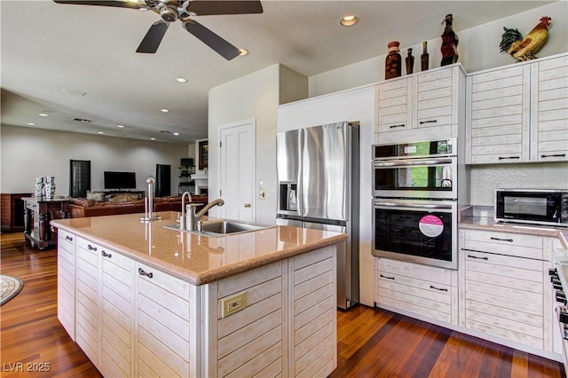 7889 Rancho Mirage Dr, Las Vegas, NV 89113 - kitchen with appliances with stainless steel finishes, dark wood-style floors, a center island with sink, ceiling fan, and white cabinetry