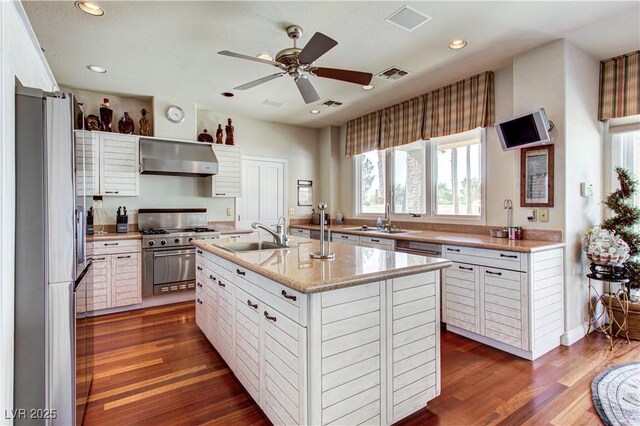 7889 Rancho Mirage Dr, Las Vegas, NV 89113 - kitchen featuring appliances with stainless steel finishes, wall chimney range hood, plenty of natural light, dark wood-style flooring, and recessed lighting
