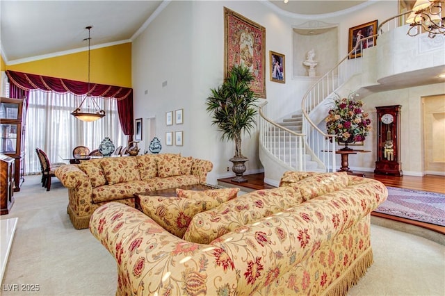 7889 Rancho Mirage Dr, Las Vegas, NV 89113 - carpeted living room featuring high vaulted ceiling, stairs, and crown molding