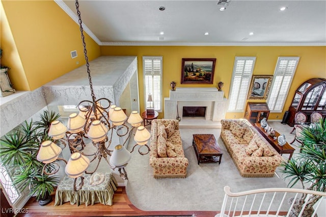 7889 Rancho Mirage Dr, Las Vegas, NV 89113 - living room with ornamental molding, a premium fireplace, recessed lighting, wood finished floors, and a chandelier